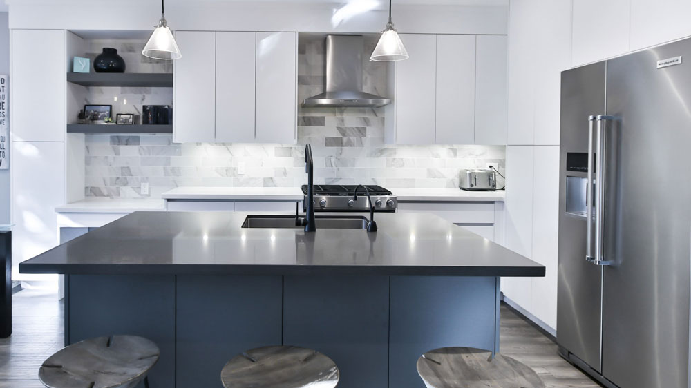 A kitchen with a large french door KitchenAid refrigerator